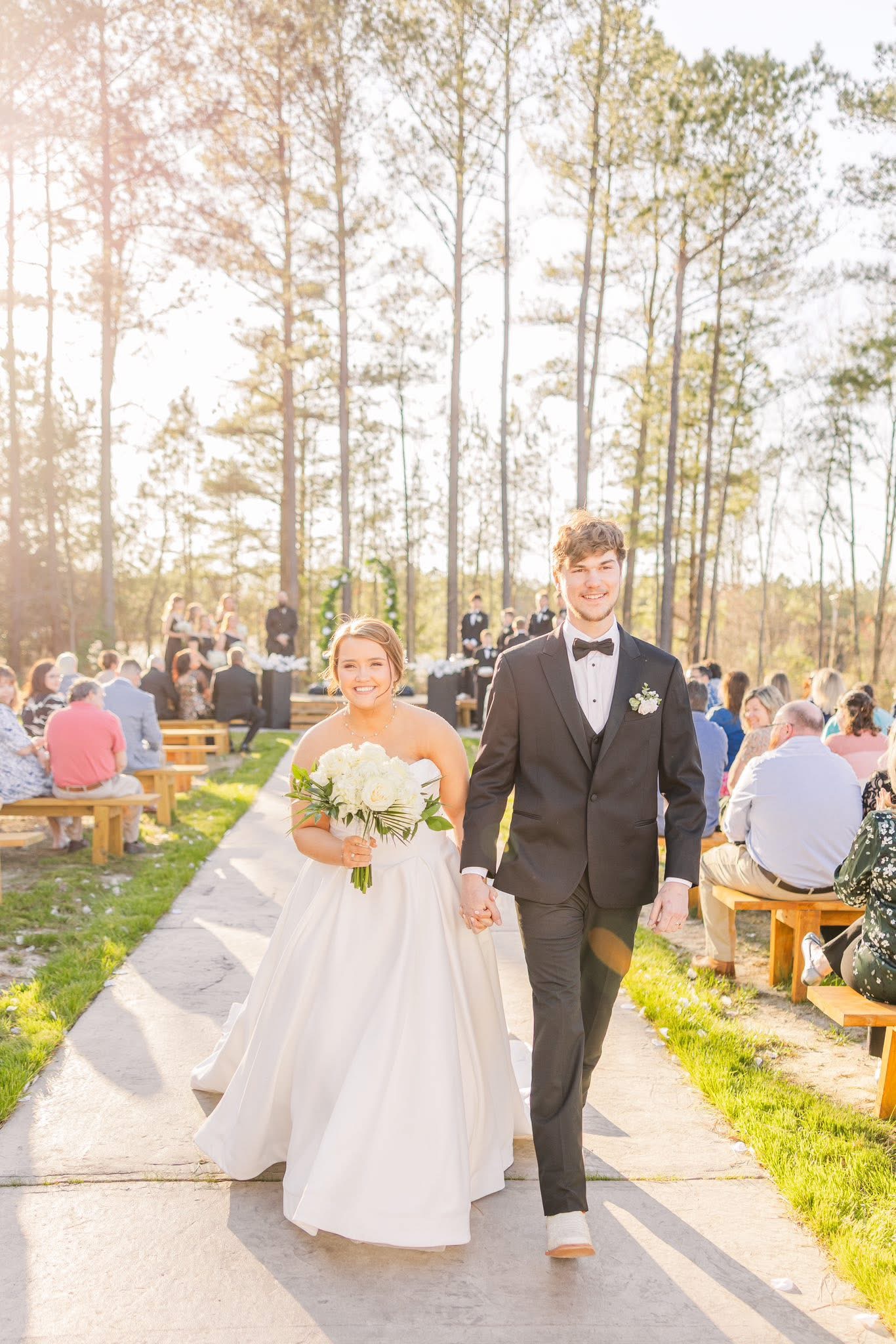 A newly married couple celebrating among the trees at Factory 633